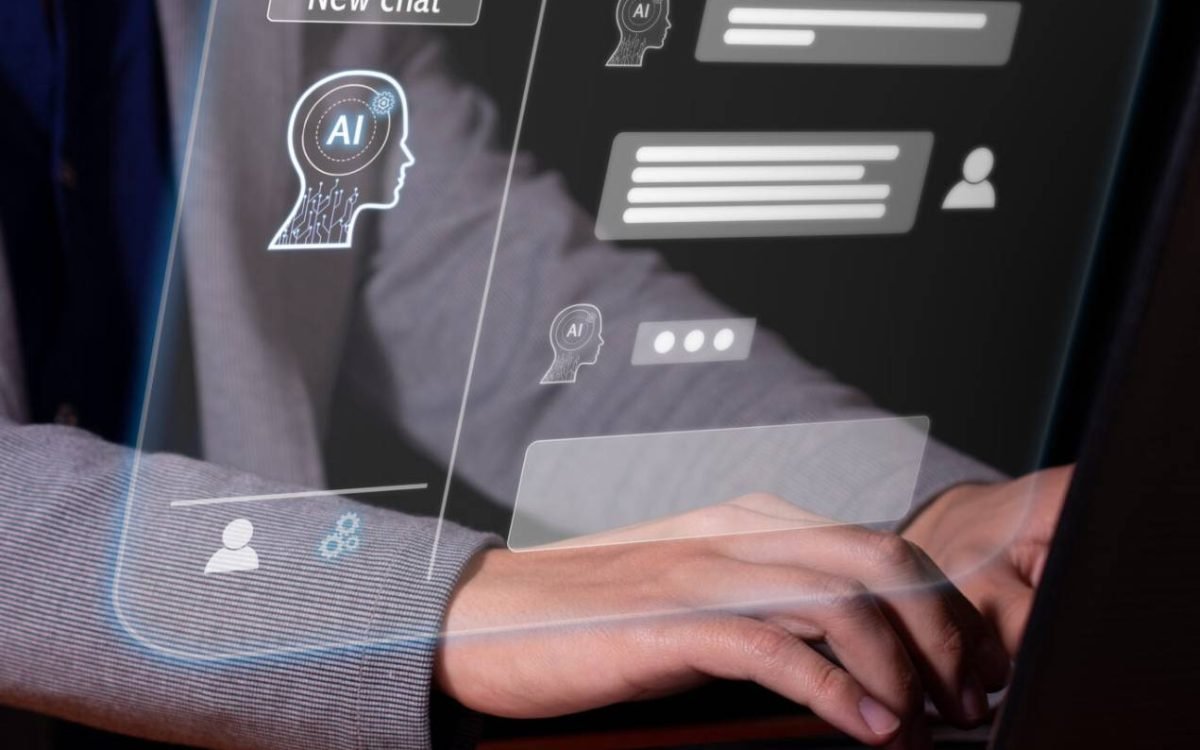 Hands typing on a laptop with a chat interface overlaid